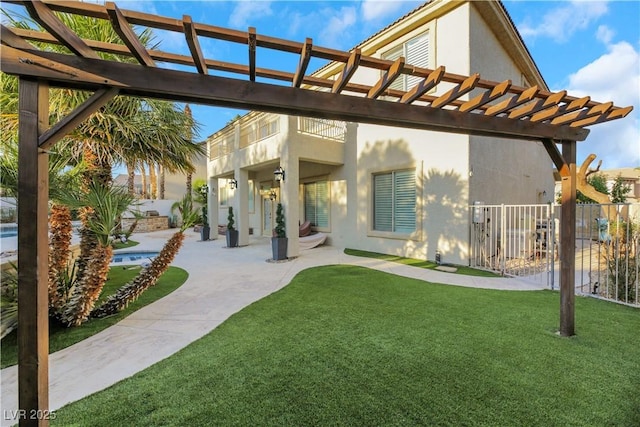 back of house with a balcony, a pergola, a patio, and a yard