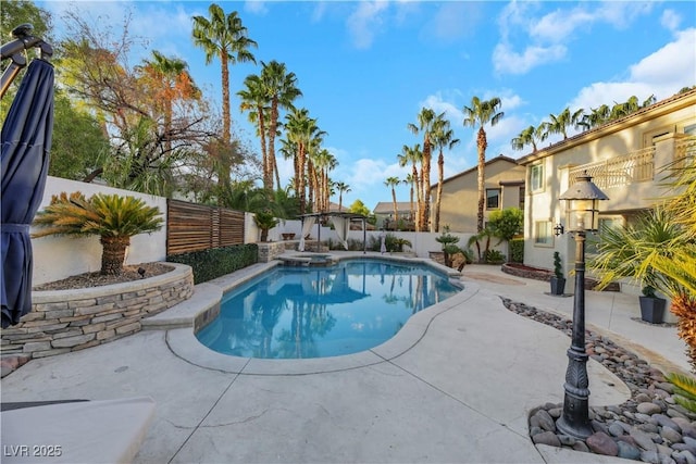 view of swimming pool featuring a patio and an in ground hot tub