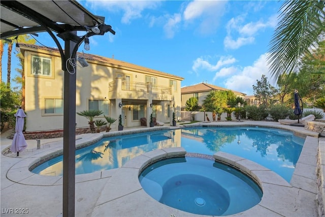 view of swimming pool with an in ground hot tub