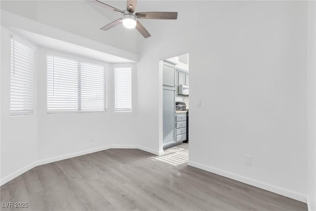 empty room featuring light wood-type flooring and ceiling fan