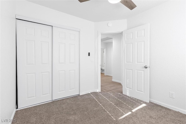 unfurnished bedroom with a closet, ceiling fan, and carpet flooring