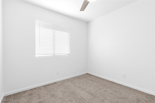 spare room featuring ceiling fan and carpet