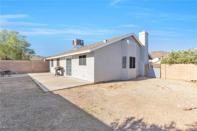 rear view of house with a patio area and central air condition unit