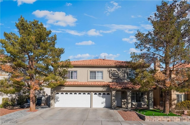 mediterranean / spanish home with a garage