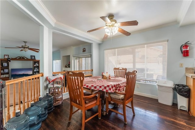 dining space with ceiling fan, dark hardwood / wood-style flooring, and ornamental molding