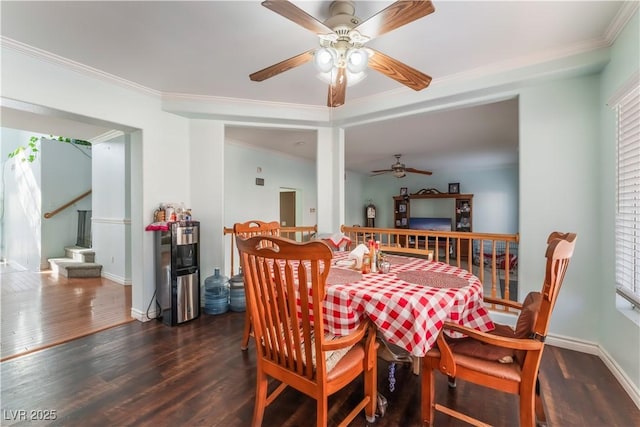 dining space featuring dark wood-type flooring, a wealth of natural light, and crown molding