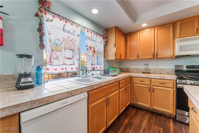 kitchen with white appliances, tile counters, sink, dark hardwood / wood-style floors, and ornamental molding