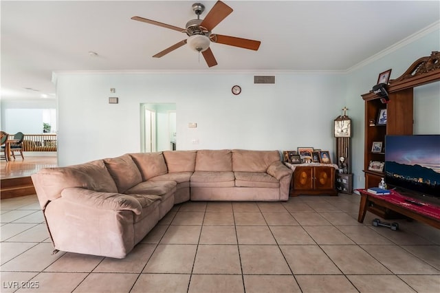 living room featuring ceiling fan, light tile patterned flooring, and ornamental molding