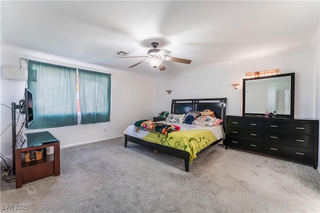 carpeted bedroom featuring ceiling fan and ornamental molding