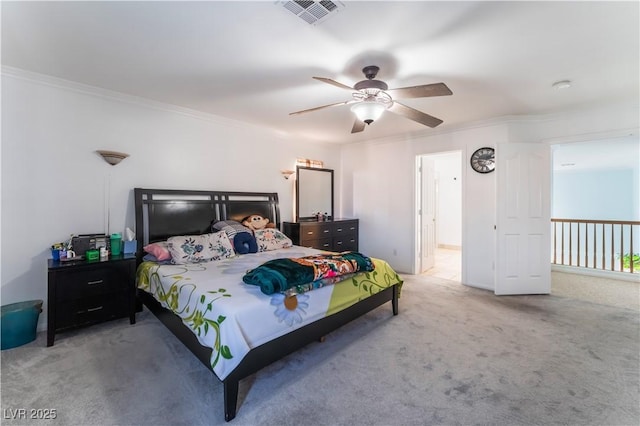 carpeted bedroom featuring ceiling fan and crown molding