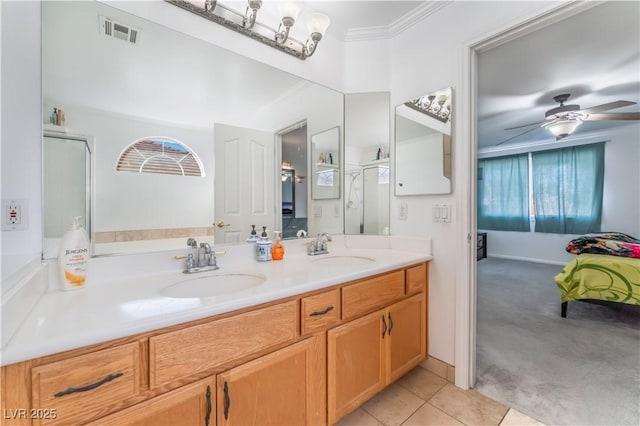 bathroom featuring a shower with door, ceiling fan, tile patterned floors, crown molding, and vanity