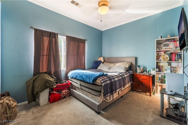 carpeted bedroom with ceiling fan and crown molding