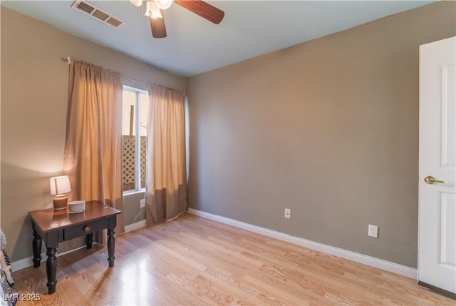 empty room featuring ceiling fan and light hardwood / wood-style floors