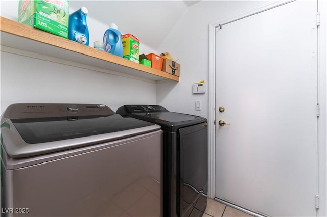 laundry room featuring light tile patterned floors and washer and dryer