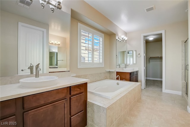 bathroom with tile patterned floors, vanity, and separate shower and tub