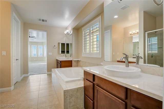 bathroom with ceiling fan, shower with separate bathtub, vanity, and tile patterned flooring