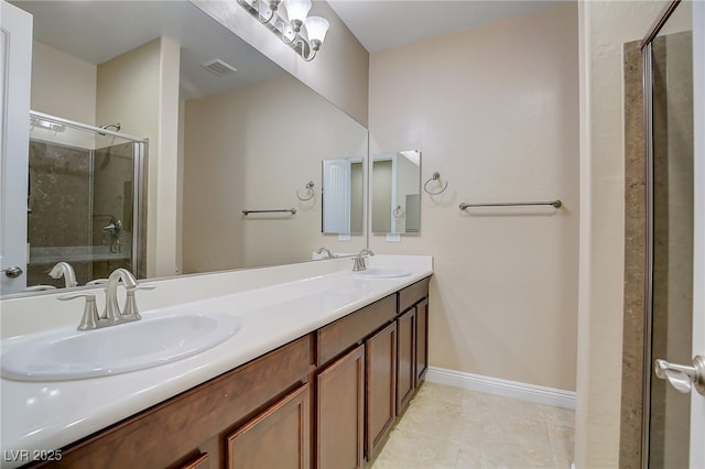 bathroom with tile patterned floors, walk in shower, and vanity