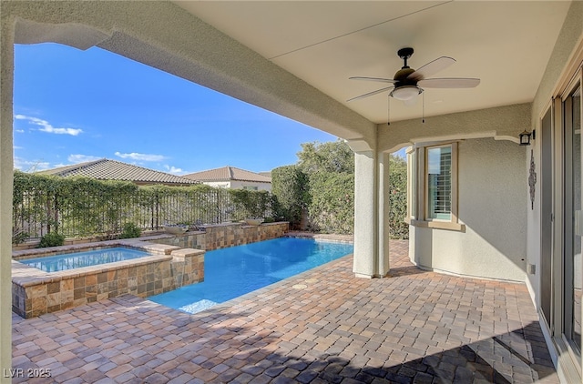 view of pool with ceiling fan, a patio, and an in ground hot tub