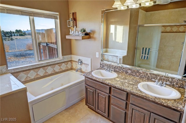 bathroom with independent shower and bath, tile patterned floors, and vanity