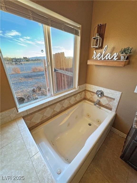 bathroom with tile patterned floors and a tub to relax in