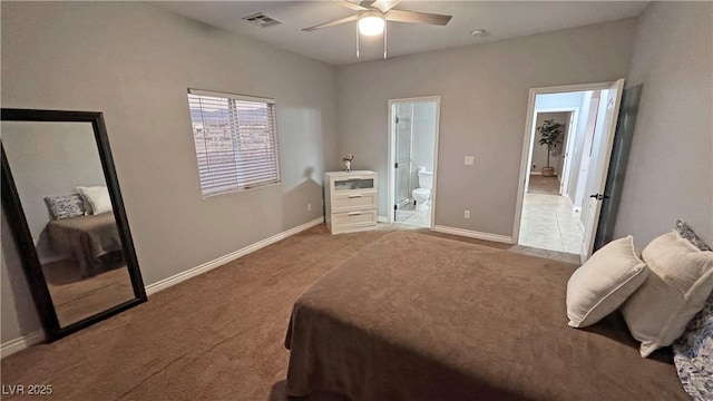 bedroom featuring ceiling fan, ensuite bath, and light colored carpet