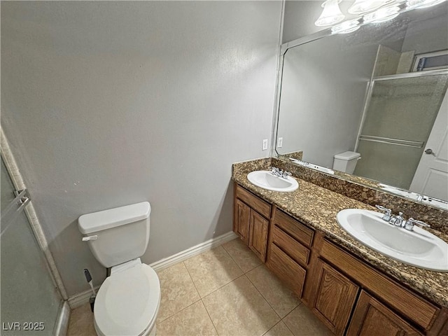 bathroom with a shower with shower door, toilet, vanity, and tile patterned flooring