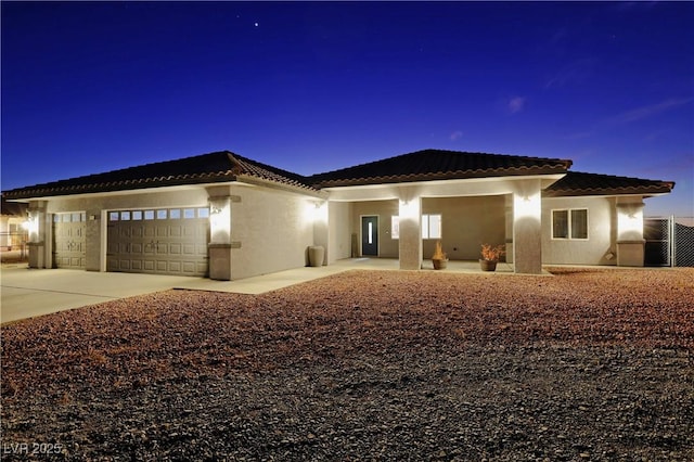 mediterranean / spanish home with a garage