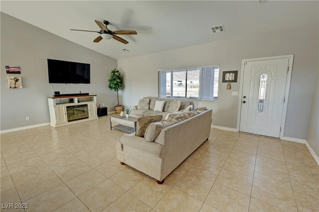 living room featuring lofted ceiling, ceiling fan, and light tile patterned flooring