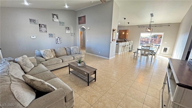 living room featuring vaulted ceiling and light tile patterned flooring