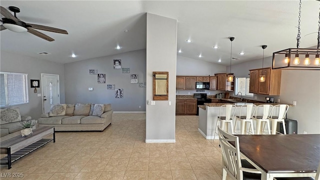 kitchen with ceiling fan, sink, lofted ceiling, pendant lighting, and black appliances