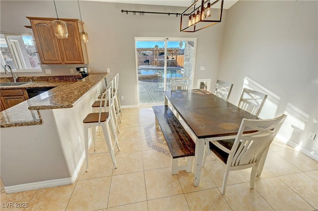 dining space with light tile patterned floors, plenty of natural light, and sink