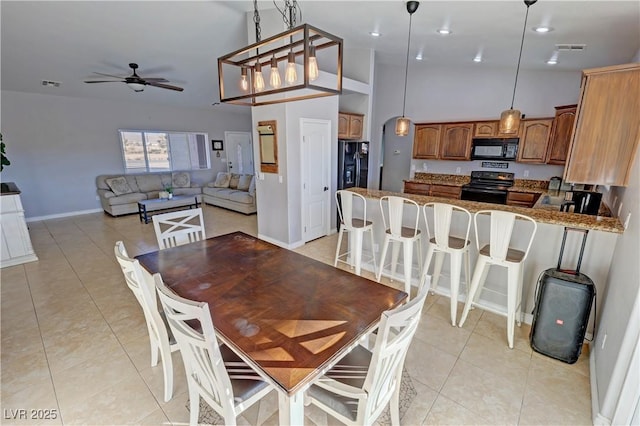 tiled dining space with ceiling fan