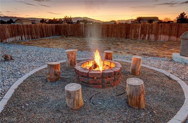 yard at dusk with an outdoor fire pit