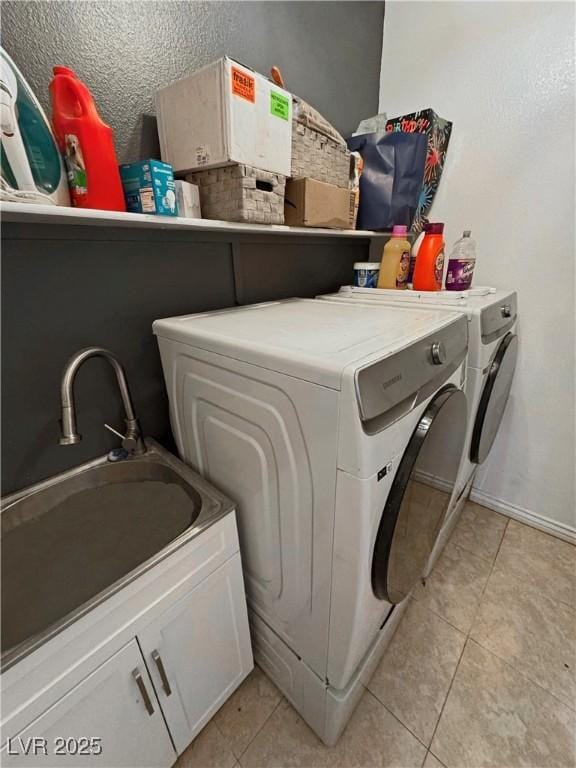 clothes washing area featuring cabinets, independent washer and dryer, and light tile patterned flooring