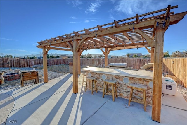 view of patio / terrace with a pergola and exterior bar