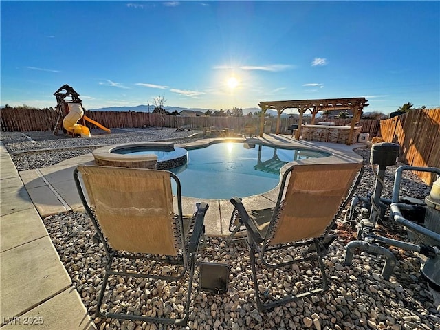 view of swimming pool with an in ground hot tub and a playground