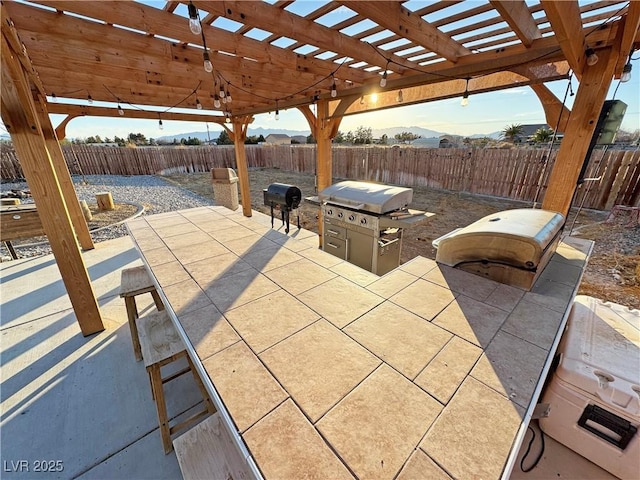 view of patio featuring area for grilling and a pergola