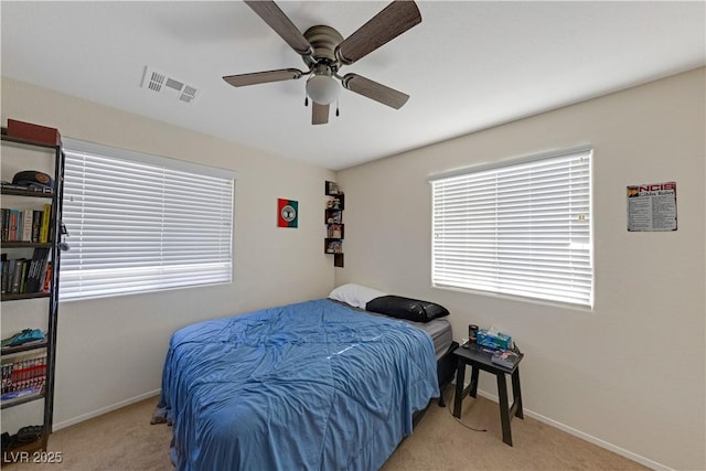 bedroom with ceiling fan and light colored carpet