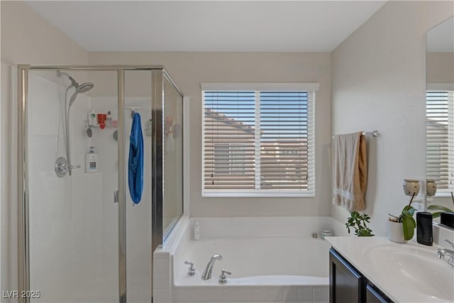 bathroom with plus walk in shower, plenty of natural light, and vanity