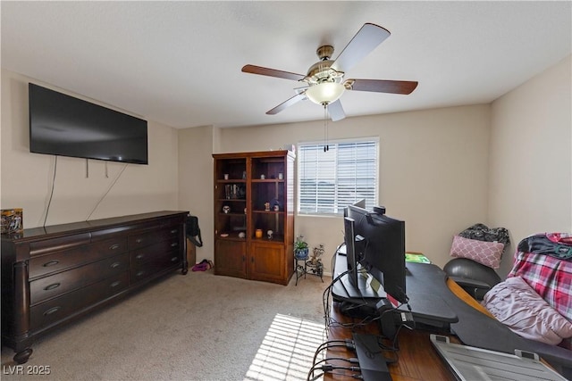 carpeted office with ceiling fan