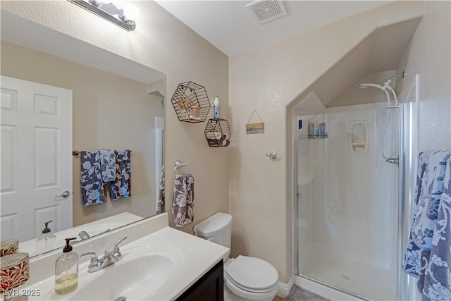 bathroom with an enclosed shower, vanity, and toilet