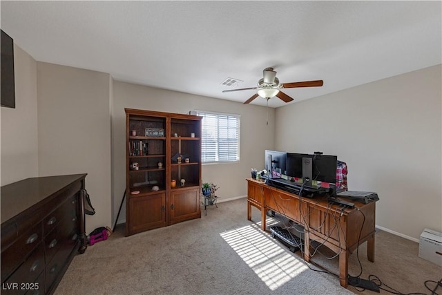 office space with ceiling fan and light carpet