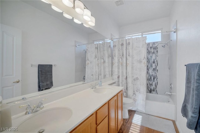 full bathroom featuring toilet, vanity, and shower / tub combo with curtain