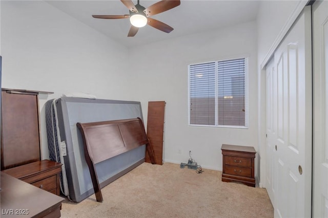 bedroom with light carpet, ceiling fan, and a closet