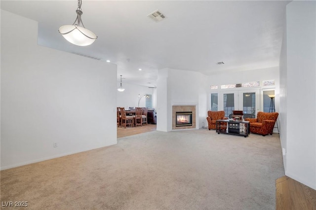 unfurnished living room featuring light carpet