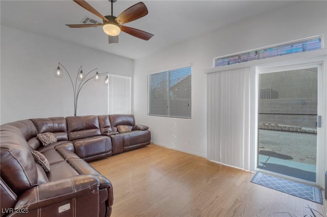 living room featuring ceiling fan and light wood-type flooring