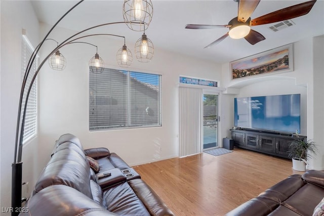 living room with ceiling fan and light hardwood / wood-style flooring