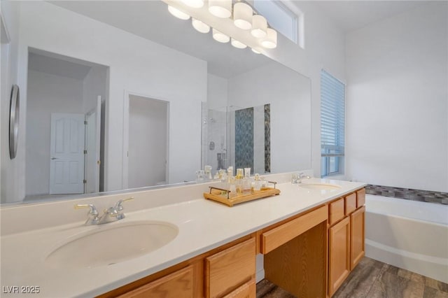 bathroom with a healthy amount of sunlight, shower with separate bathtub, hardwood / wood-style floors, and vanity