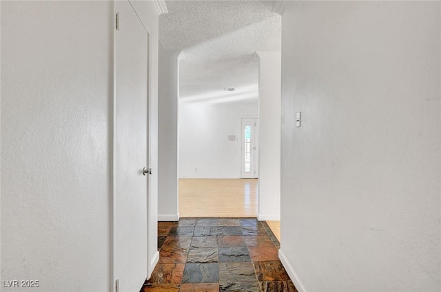 hallway featuring a textured ceiling