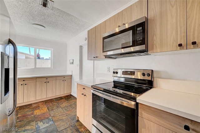 kitchen featuring crown molding, appliances with stainless steel finishes, light brown cabinets, and a textured ceiling